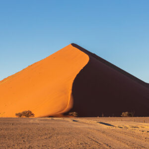 Red dunes of Sossusvlei on the Sossusvlei Sandwich Harbour tour route (illustrative destination photo)
