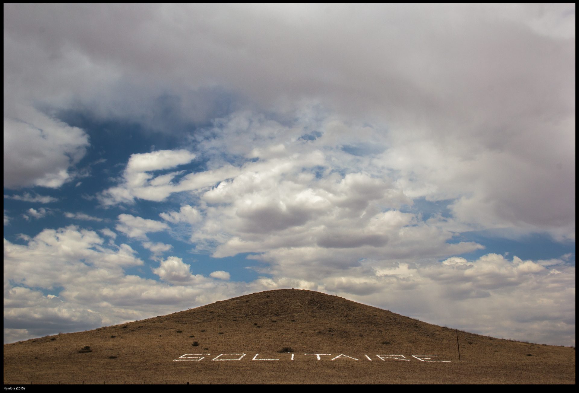 Hill and desert road landscape at the entrance to the settlement of Solitaire, Namibia