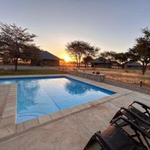 Africa Awaits Lodge and Safaris: pool terrace at sunset