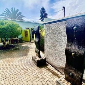 Atlantic-Square Guesthouse Swakopmund: courtyard feature and brick wall