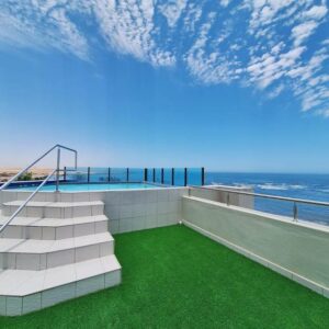 Camere da Letto Swakopmund: building, lawn and ocean frontage