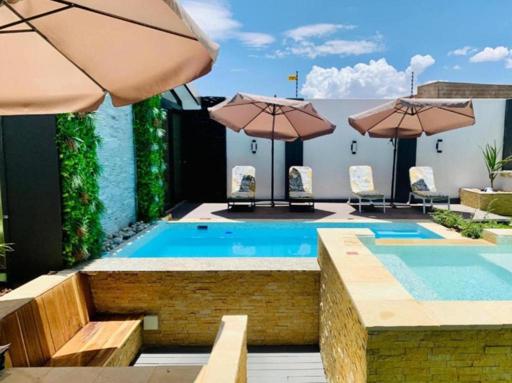 Essence Lifestyle Premium, Windhoek: pool with umbrellas and loungers
