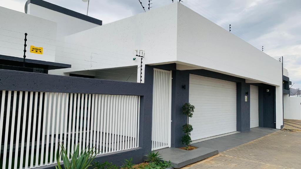 Essence Lifestyle Self-Catering, Academia, Windhoek — white building with gate