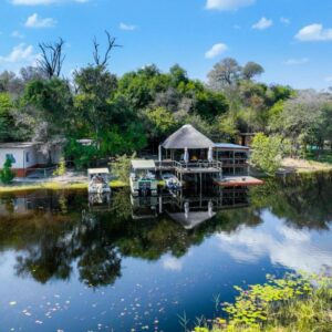 Mukolo Cabins and Camping: cabin reflected in the river