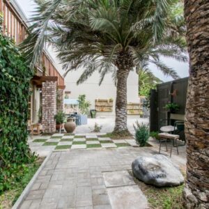 Namibia Nights Accommodation Swakopmund: palm-lined courtyard and brick building
