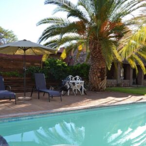 Savanna Guest Farm: swimming pool and garden seating