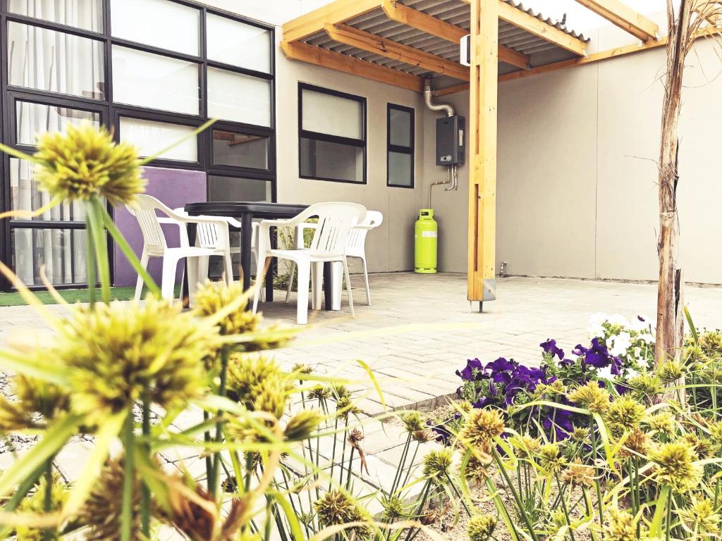 The Cabin, Swakopmund: patio with seating and flowers
