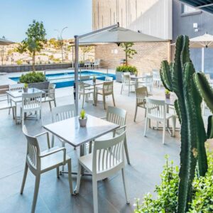 Town Lodge Windhoek: poolside patio with tables and chairs